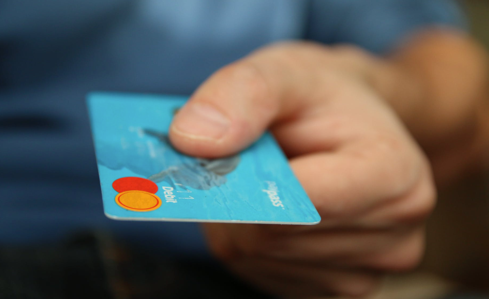 Photo of hand holding a debit card
